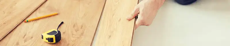 A professional installing wood flooring in Denver, CO