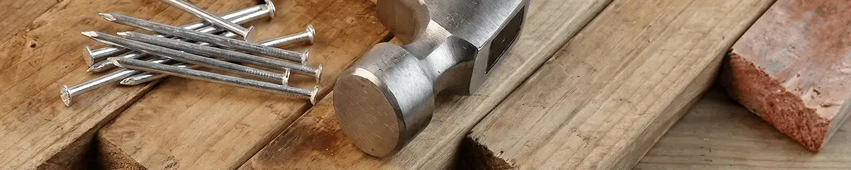 Hammer and nails on hardwood flooring boards in Denver, CO