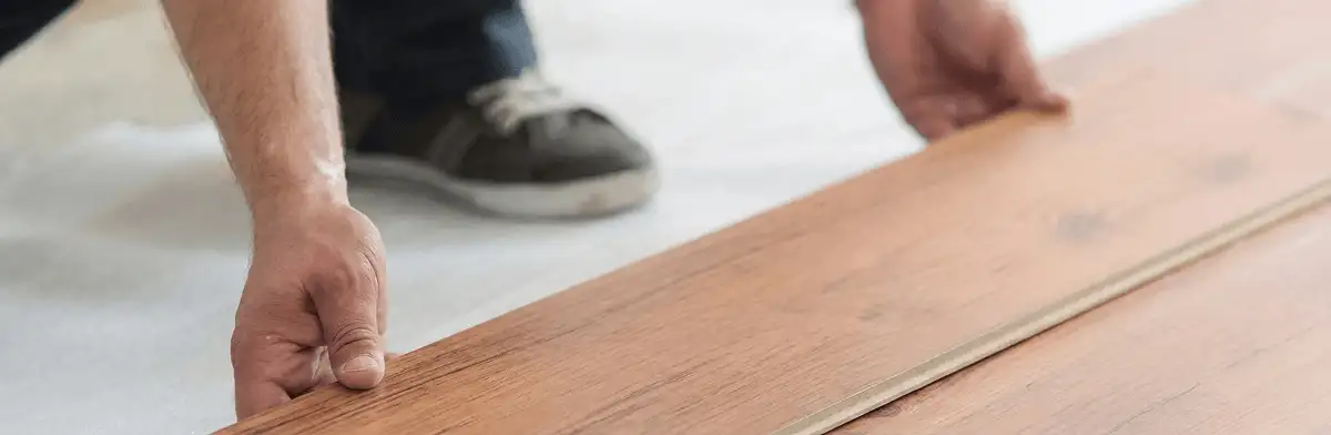 A professional installing laminate flooring in Denver, CO