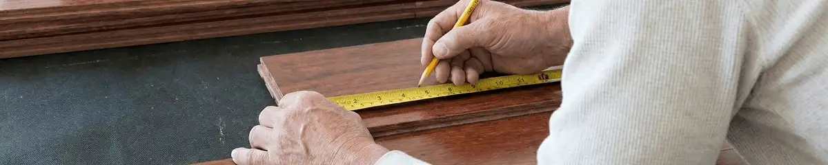 A professional installing wood flooring in Denver, CO